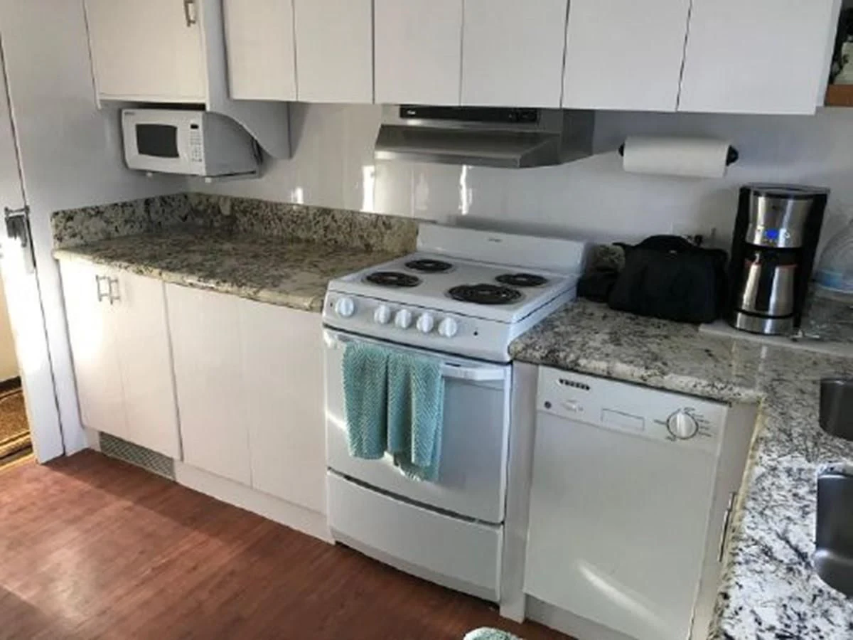 a kitchen with white appliances aboard SILVER SPIRIT II Yacht for Sale
