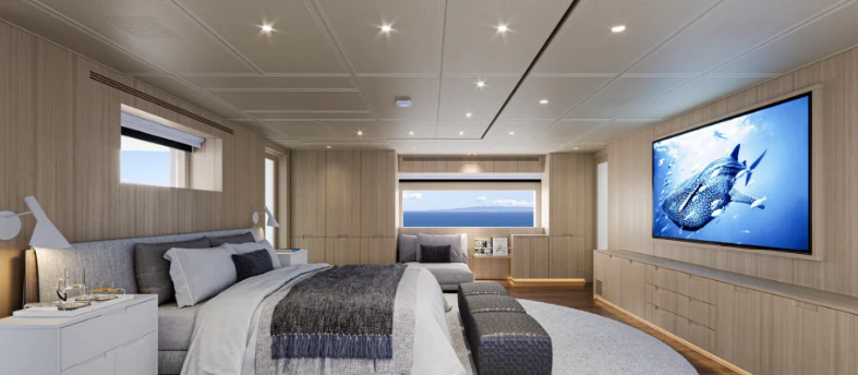 a large bedroom with a large screen aboard BEL 1 Yacht for Sale