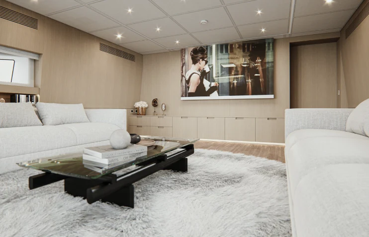 a living room with a large white couch and a large mirror aboard BEL 1 Yacht for Sale