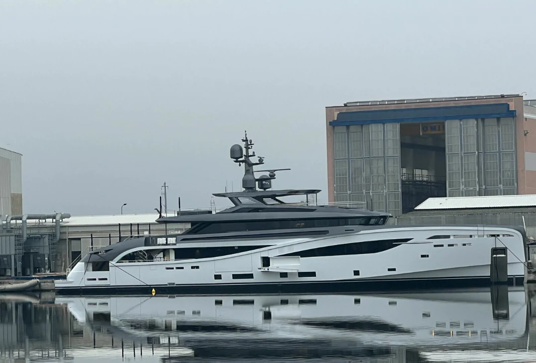 a large yacht docked in a harbor aboard BEL 1 Yacht for Sale
