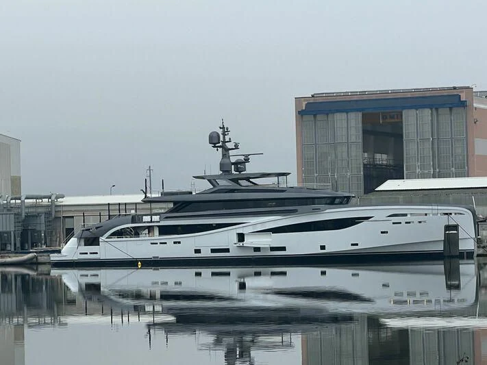 a large yacht docked at a pier aboard BEL 1 Yacht for Sale