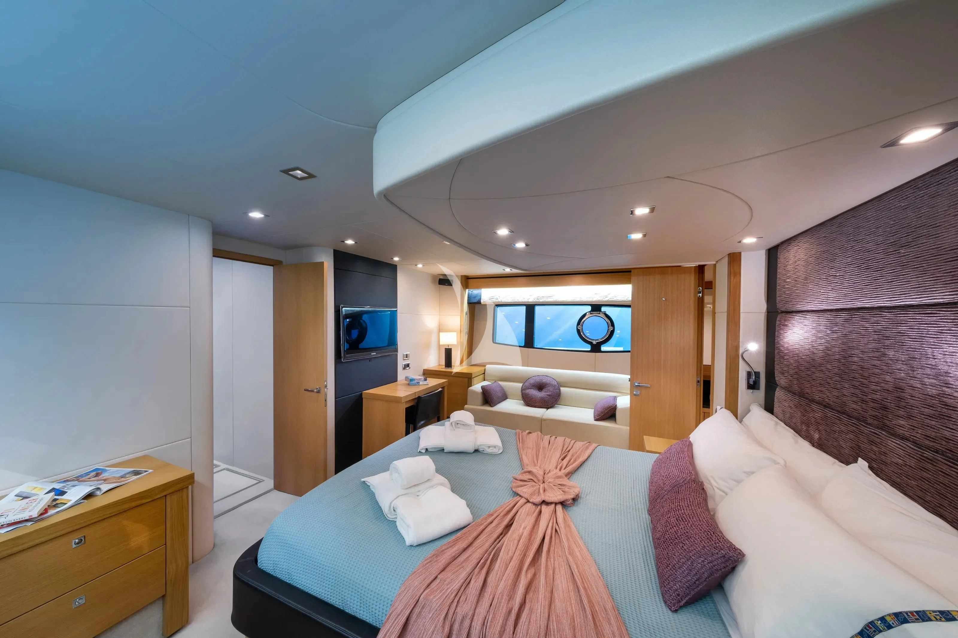 a bedroom with a bed and a television aboard POLPO Yacht for Charter