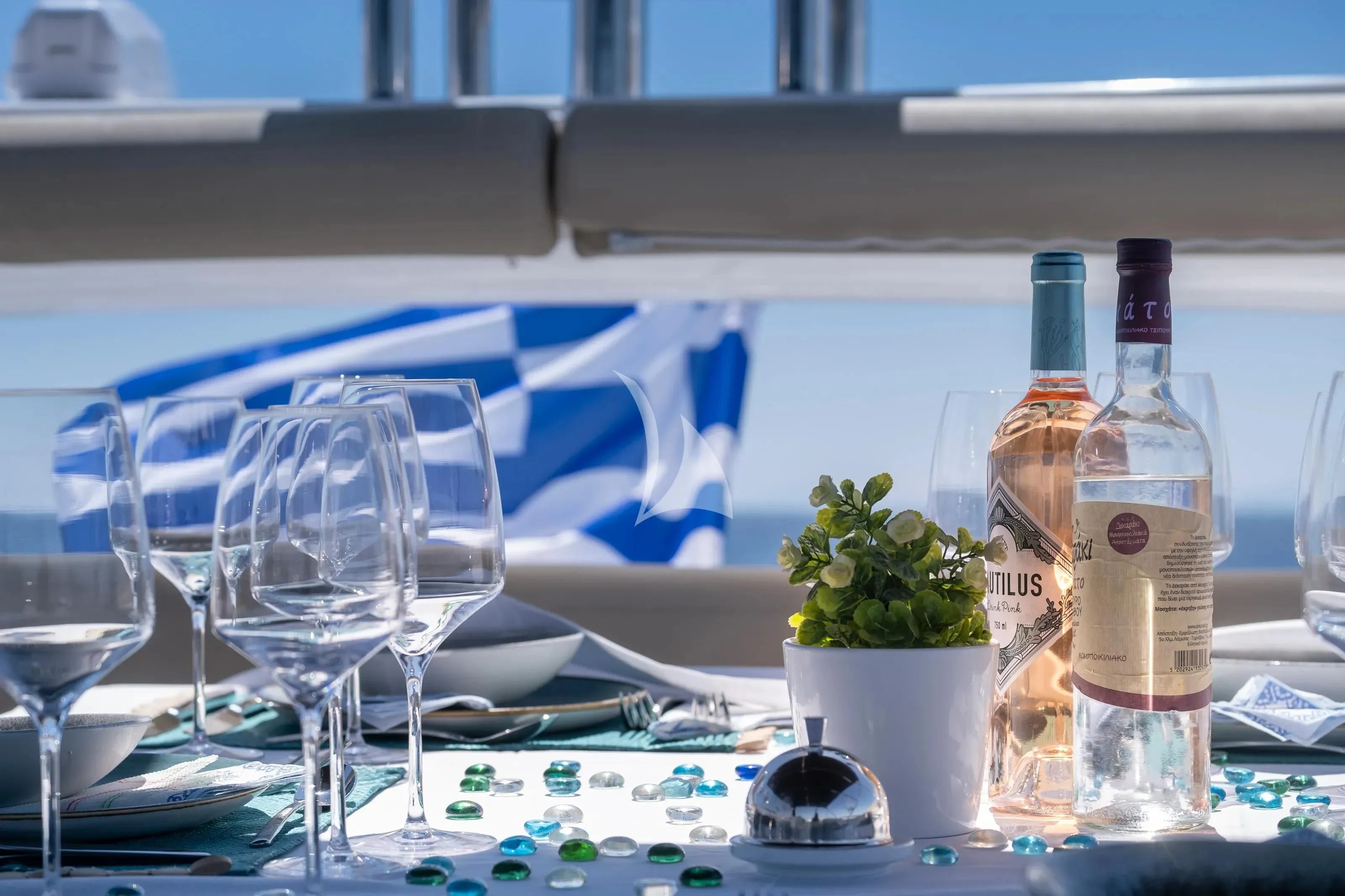 a table with wine bottles and glasses aboard POLPO Yacht for Charter
