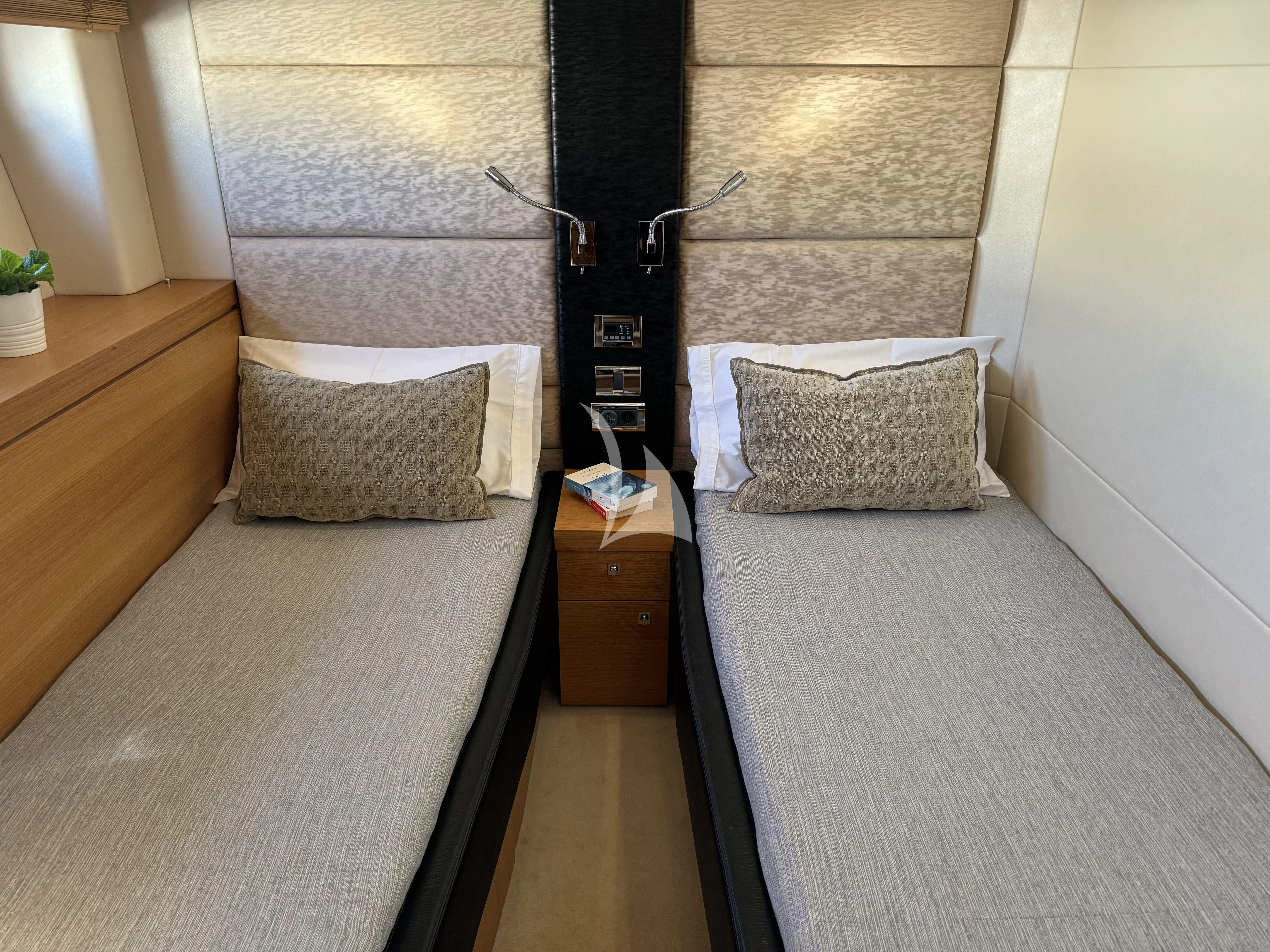 a bed with a lamp on it aboard POLPO Yacht for Charter