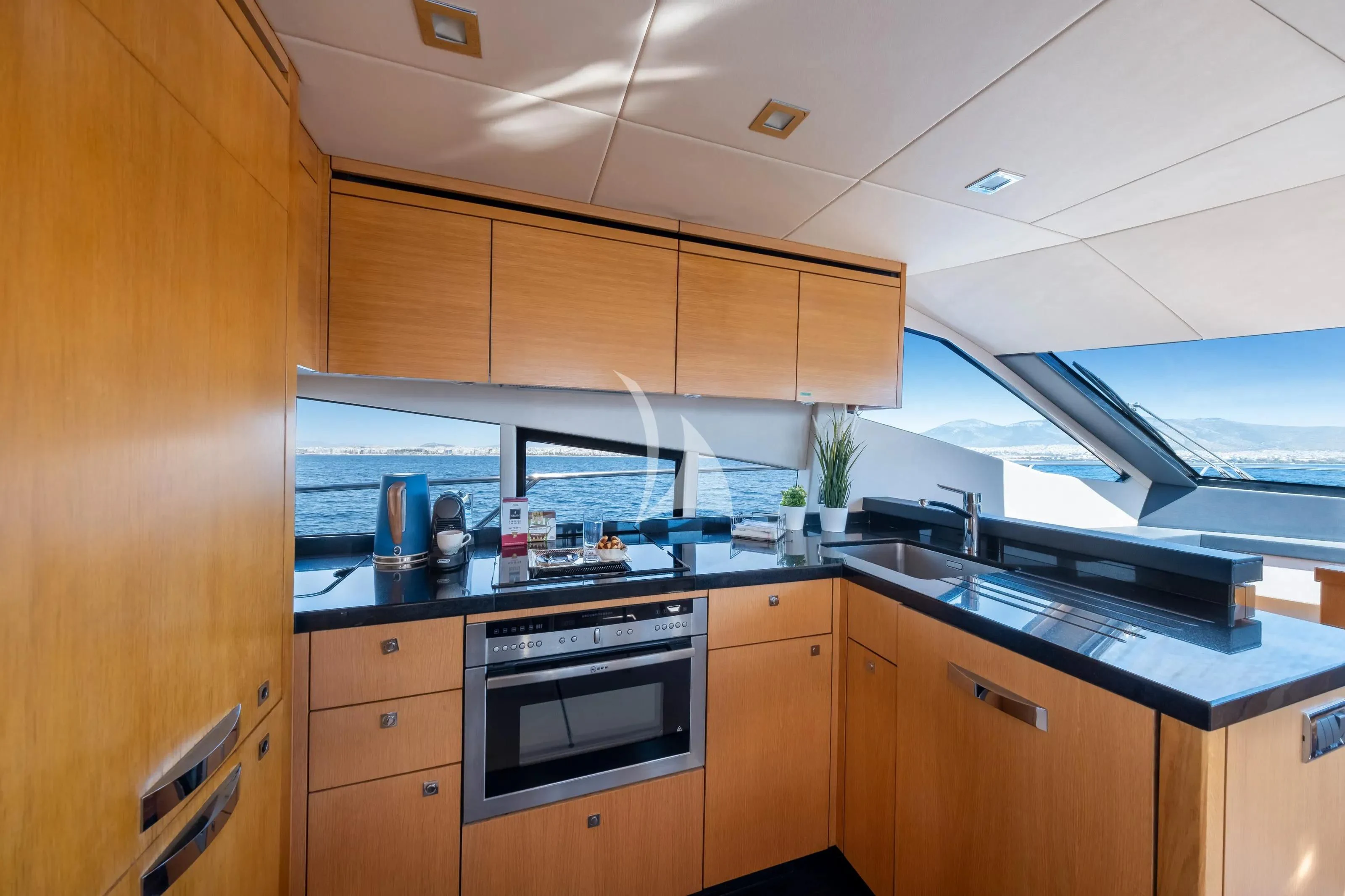 a kitchen with wooden cabinets aboard POLPO Yacht for Charter