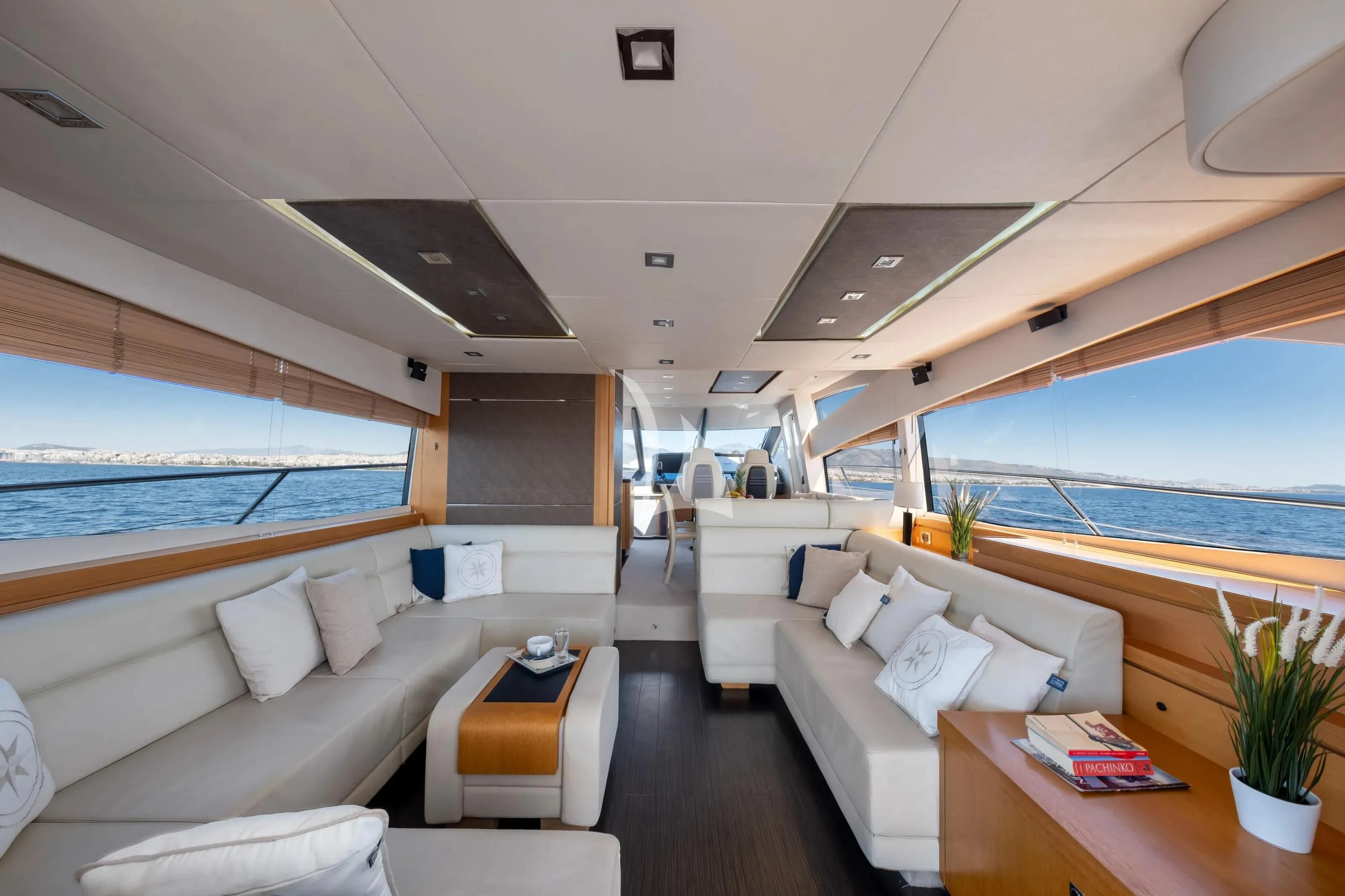 a room with a couch and a table and a window aboard POLPO Yacht for Charter