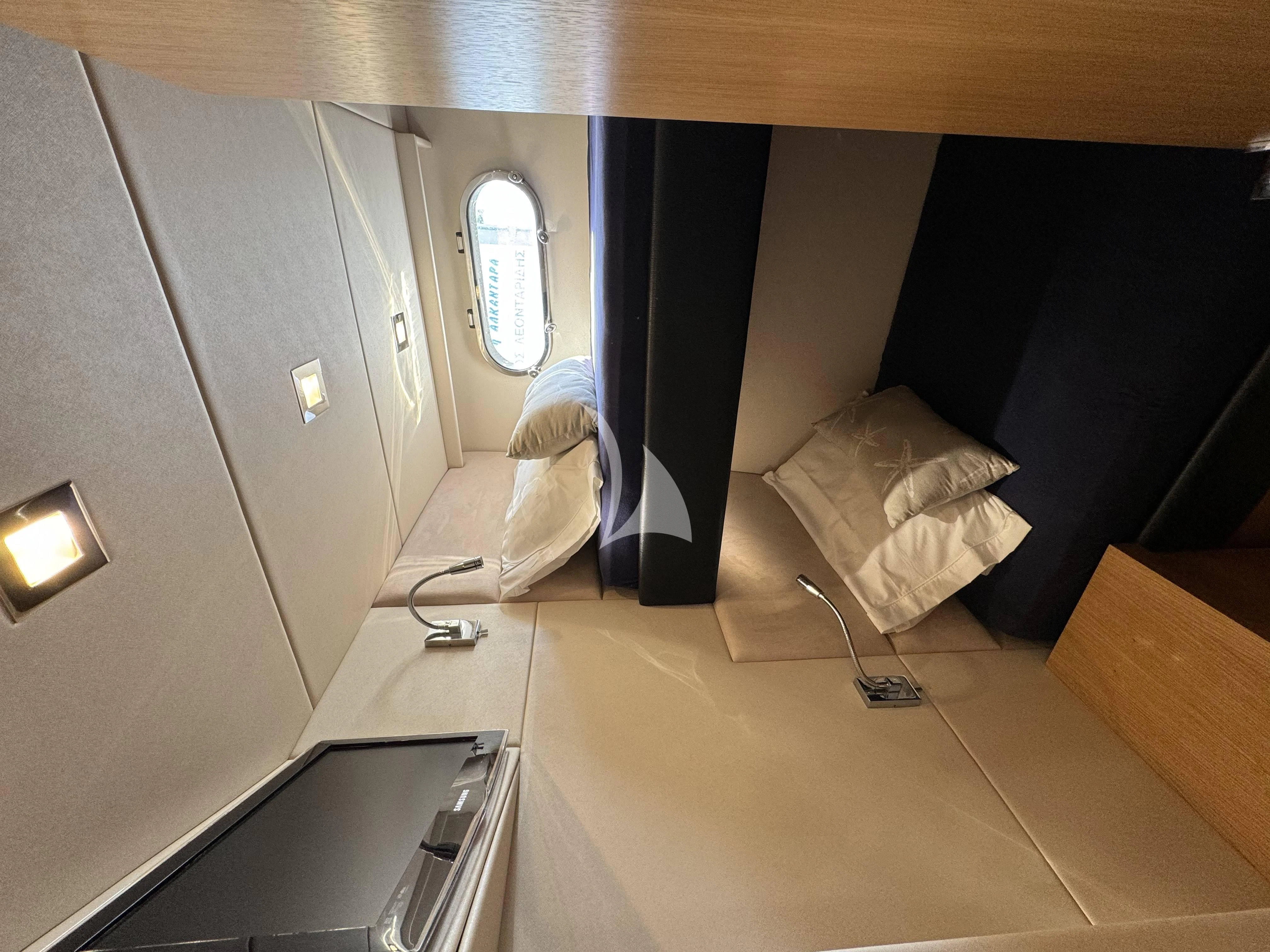 a room with a bed and a desk aboard POLPO Yacht for Charter