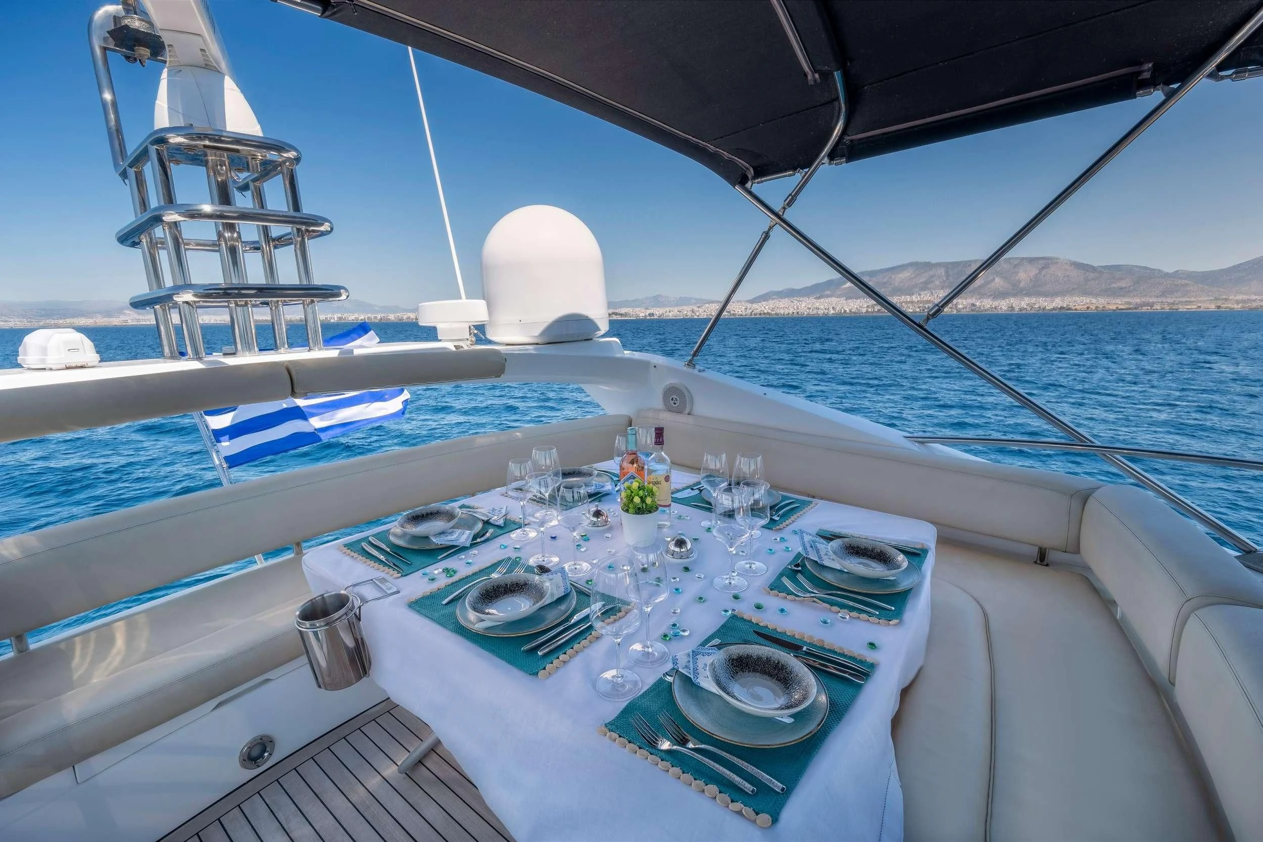 a boat with a tablecloth and plates on it aboard POLPO Yacht for Charter