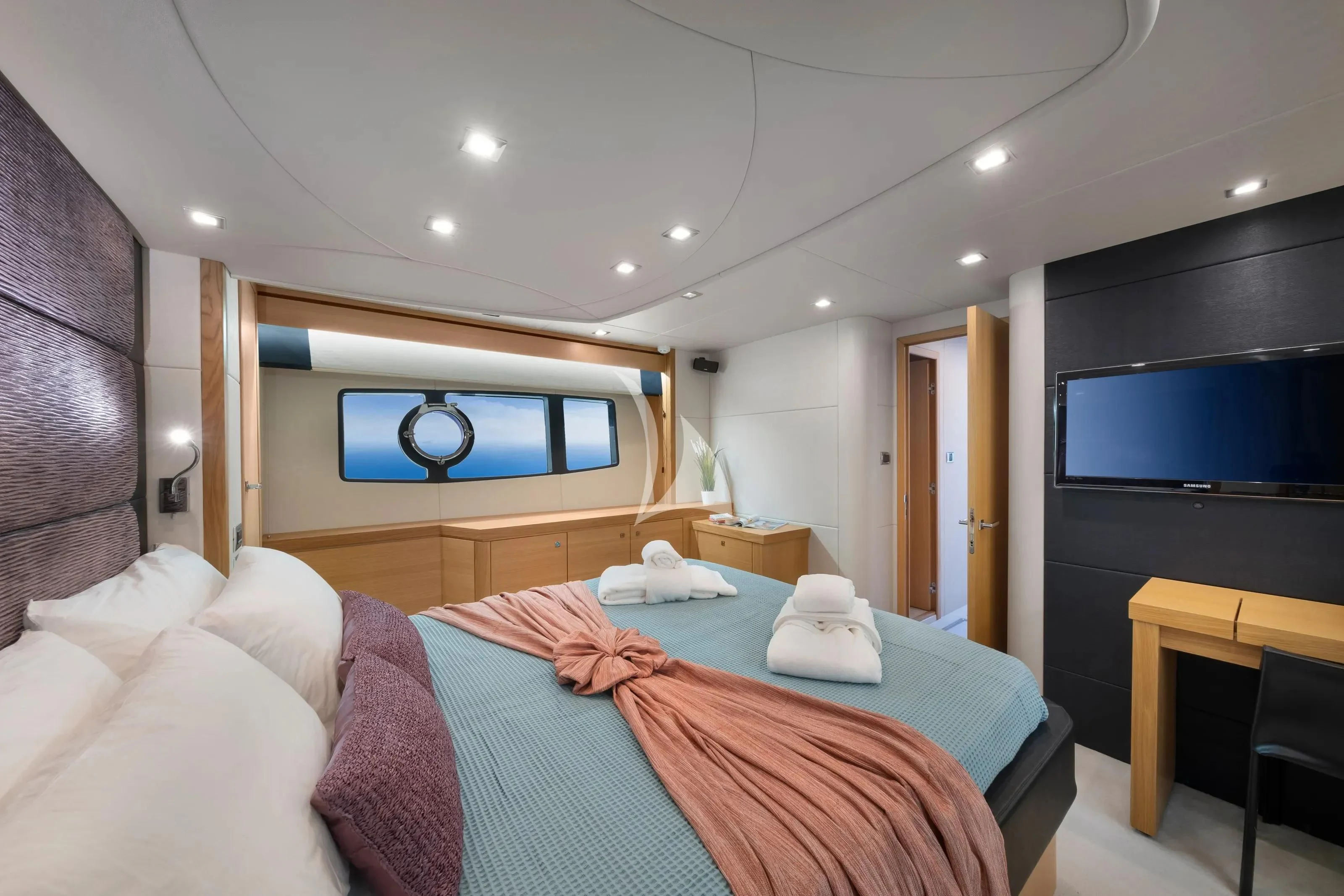 a bedroom with a bed and a tv on the wall aboard POLPO Yacht for Charter