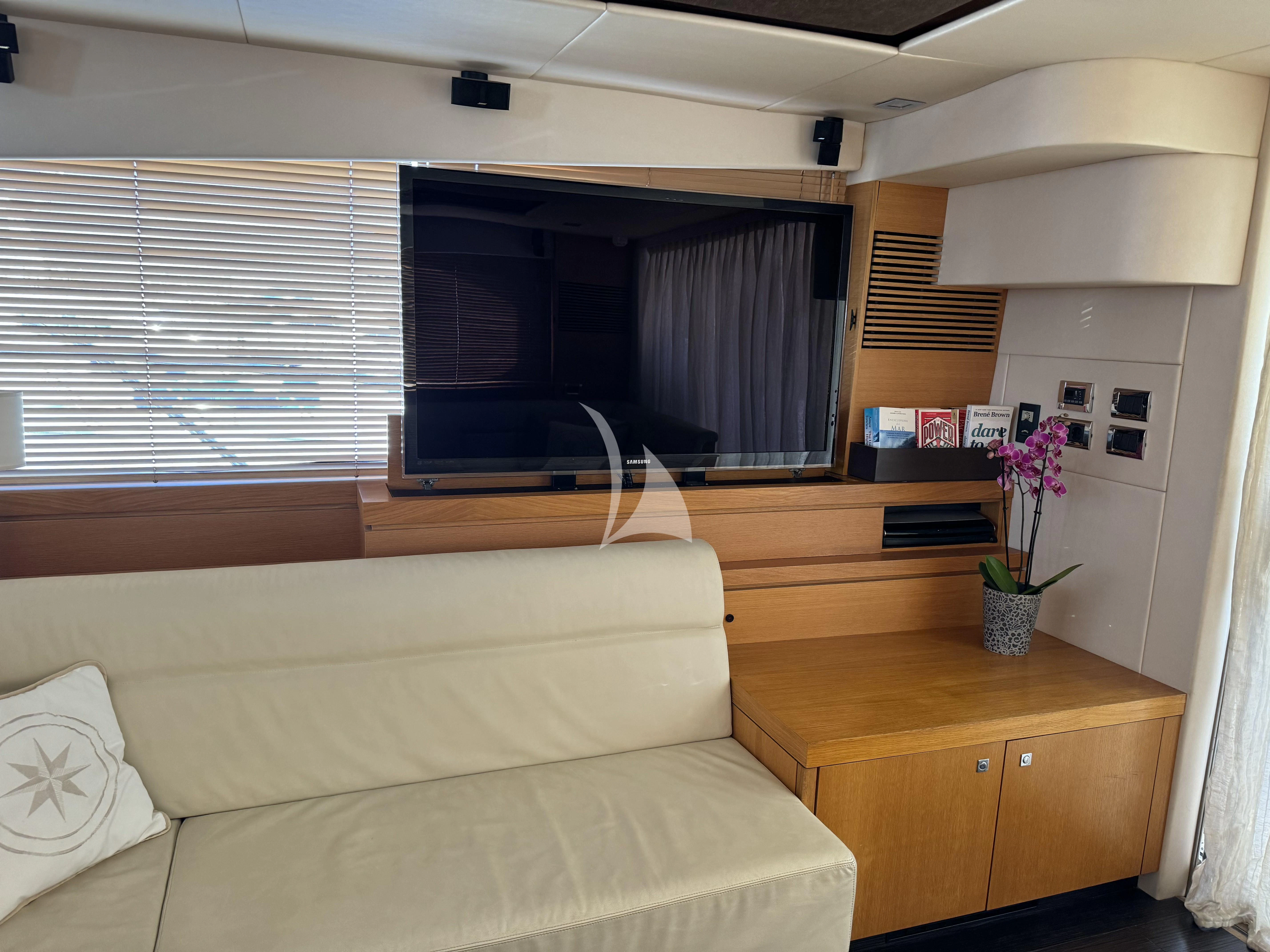 a living room with a couch and a television aboard POLPO Yacht for Charter
