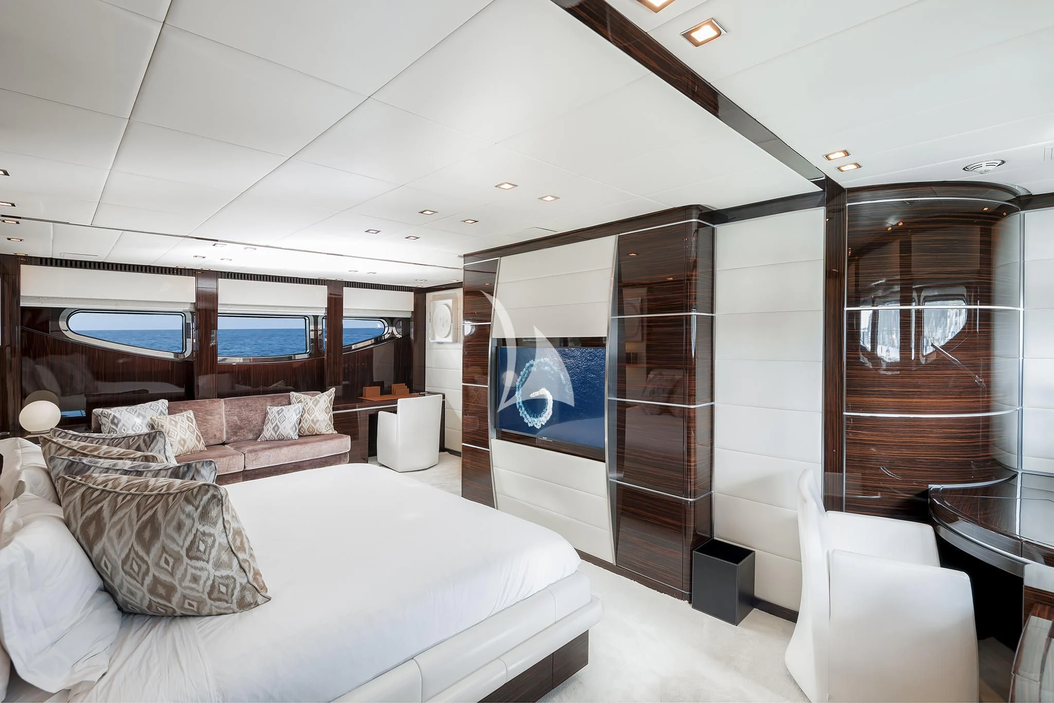 a bedroom with a bed and a large mirror aboard ANTELOPE IV Yacht for Sale