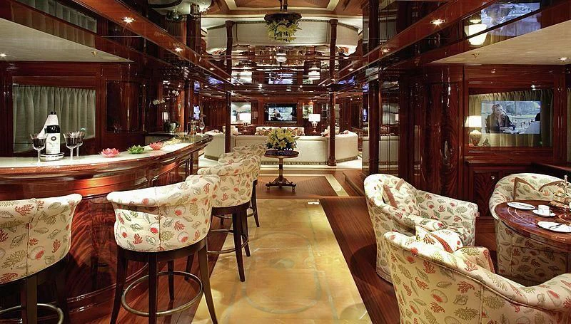 a room with a table chairs and a couch aboard EMELINA Yacht for Sale