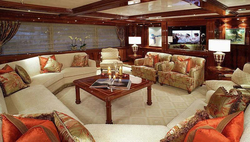 a living room with a couch and a coffee table aboard EMELINA Yacht for Sale