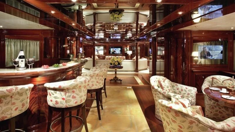 a room with chairs and tables aboard EMELINA Yacht for Sale