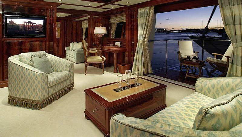 a living room with a couch and a television aboard EMELINA Yacht for Sale