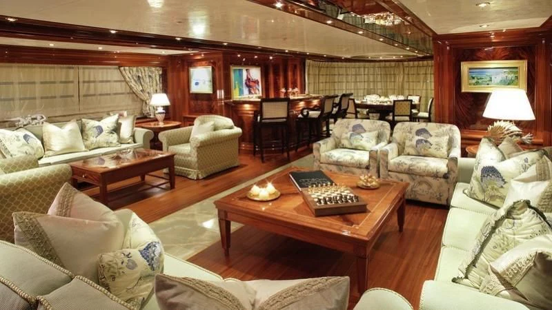 a living room with a couch and a coffee table aboard EMELINA Yacht for Sale
