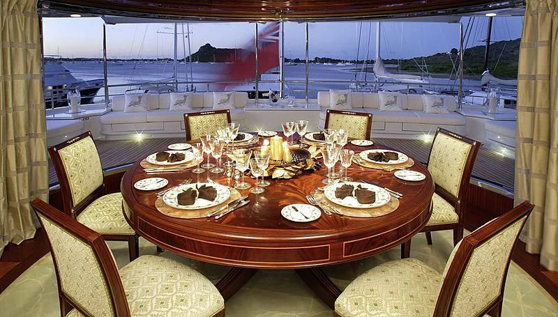 a table with plates and glasses on it aboard EMELINA Yacht for Sale
