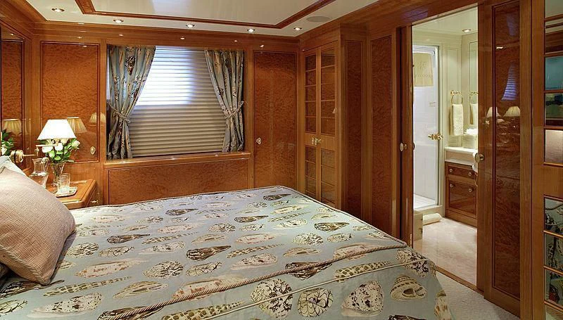 a bedroom with a bed and a door aboard EMELINA Yacht for Sale