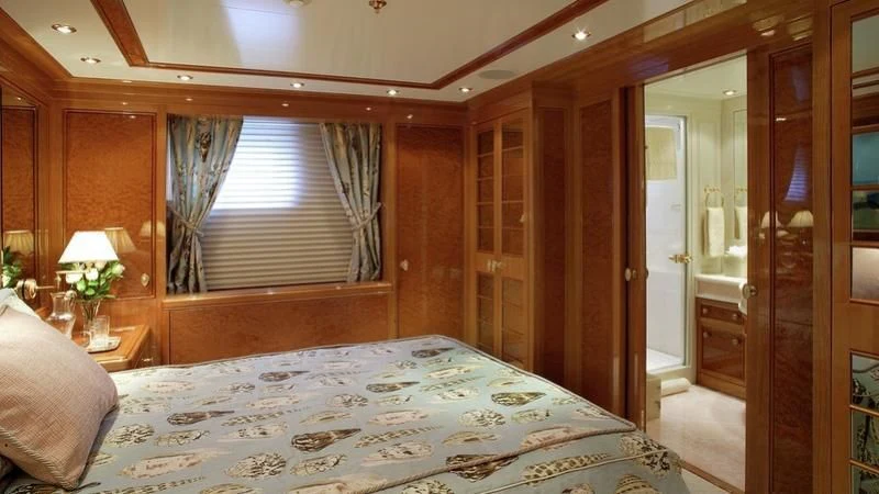 a bedroom with a bed and a door aboard EMELINA Yacht for Sale