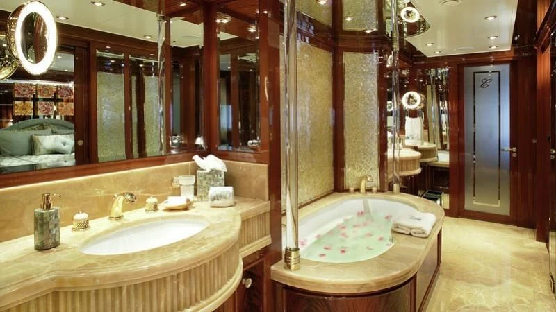 a bathroom with a tub sink and a mirror aboard EMELINA Yacht for Sale