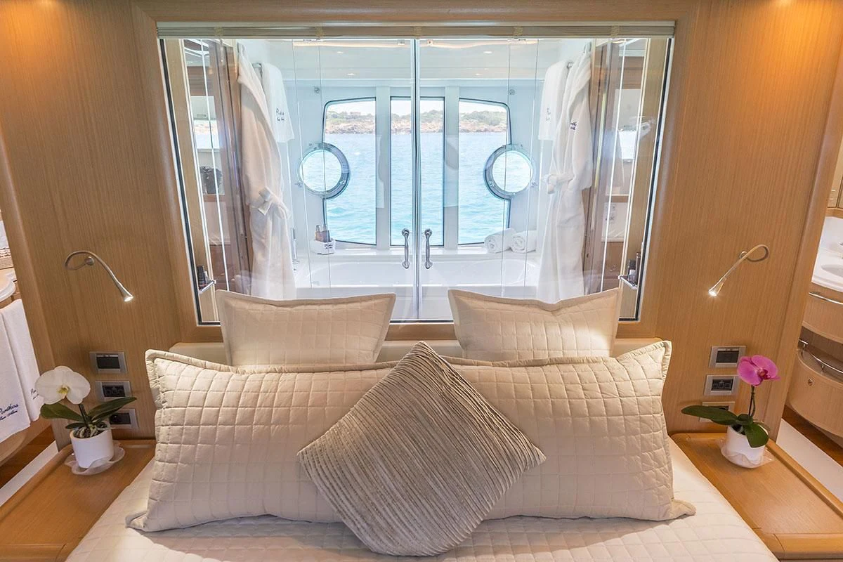 a living room with a large window aboard PORTHOS SANS ABRI Yacht for Sale