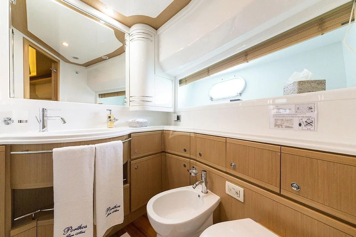 a bathroom with a sink and a toilet aboard PORTHOS SANS ABRI Yacht for Sale