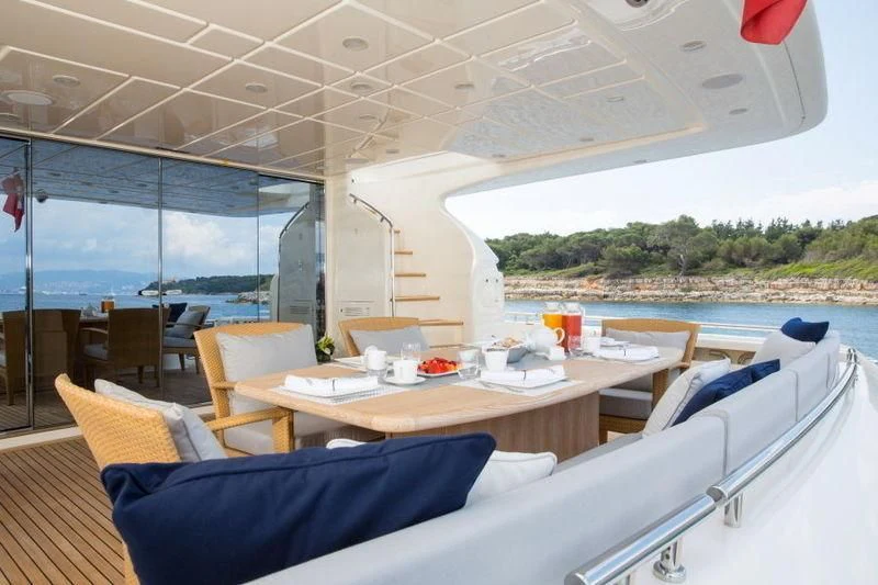 a room with a table and chairs aboard PORTHOS SANS ABRI Yacht for Sale