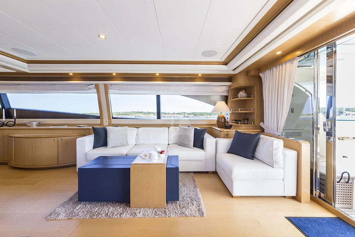 a living room with a large window aboard PORTHOS SANS ABRI Yacht for Sale