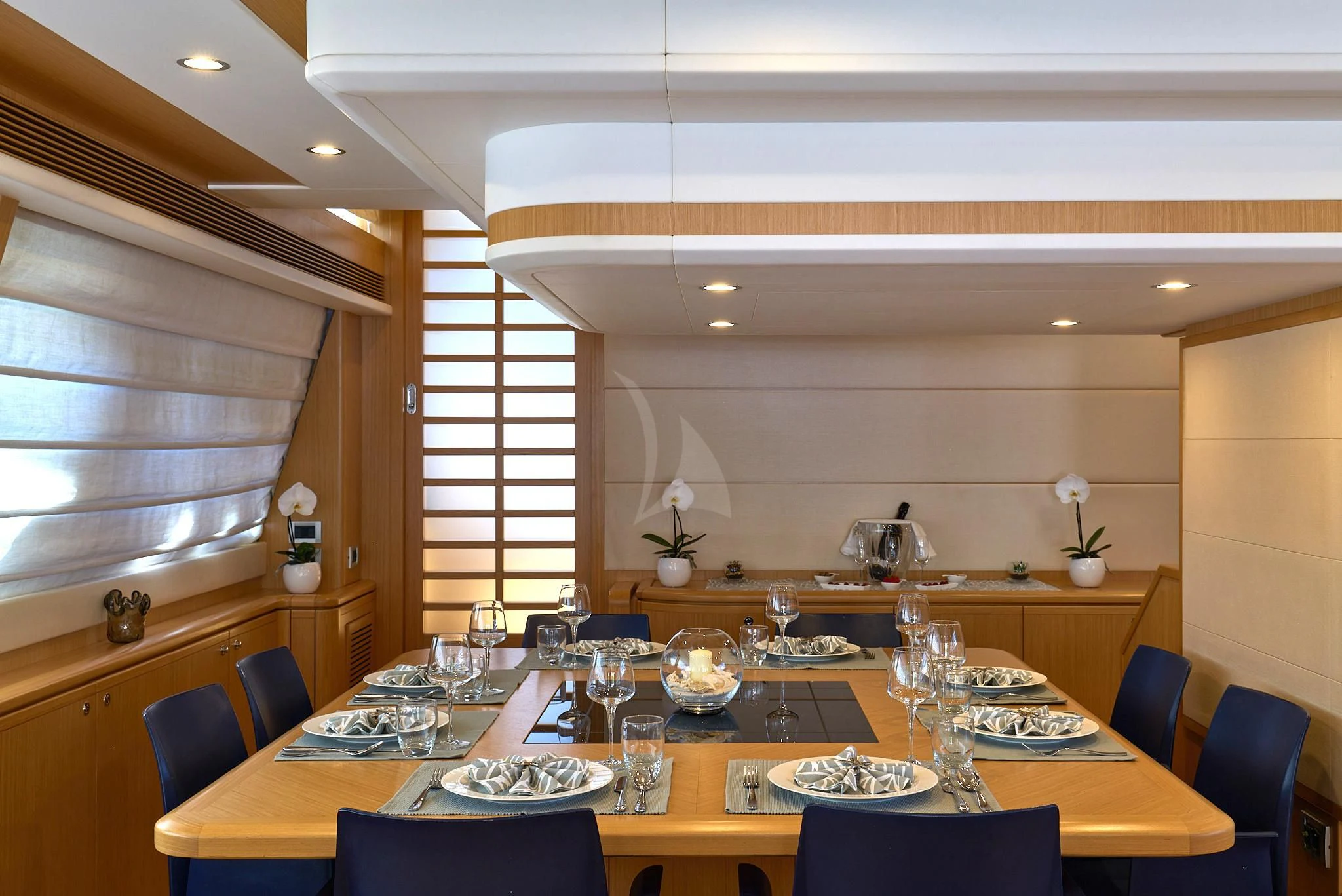 a large dining room with a table set for dinner aboard PORTHOS SANS ABRI Yacht for Sale