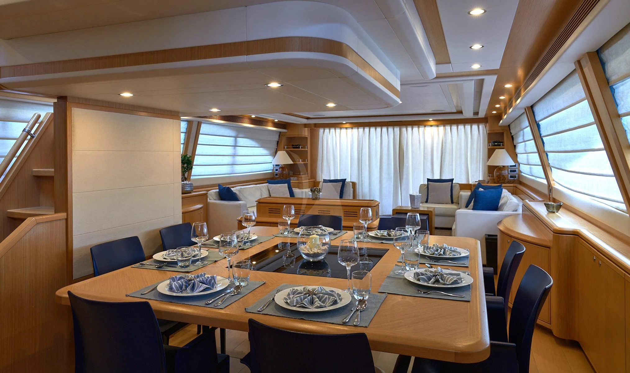 a dining room with a table set aboard PORTHOS SANS ABRI Yacht for Sale