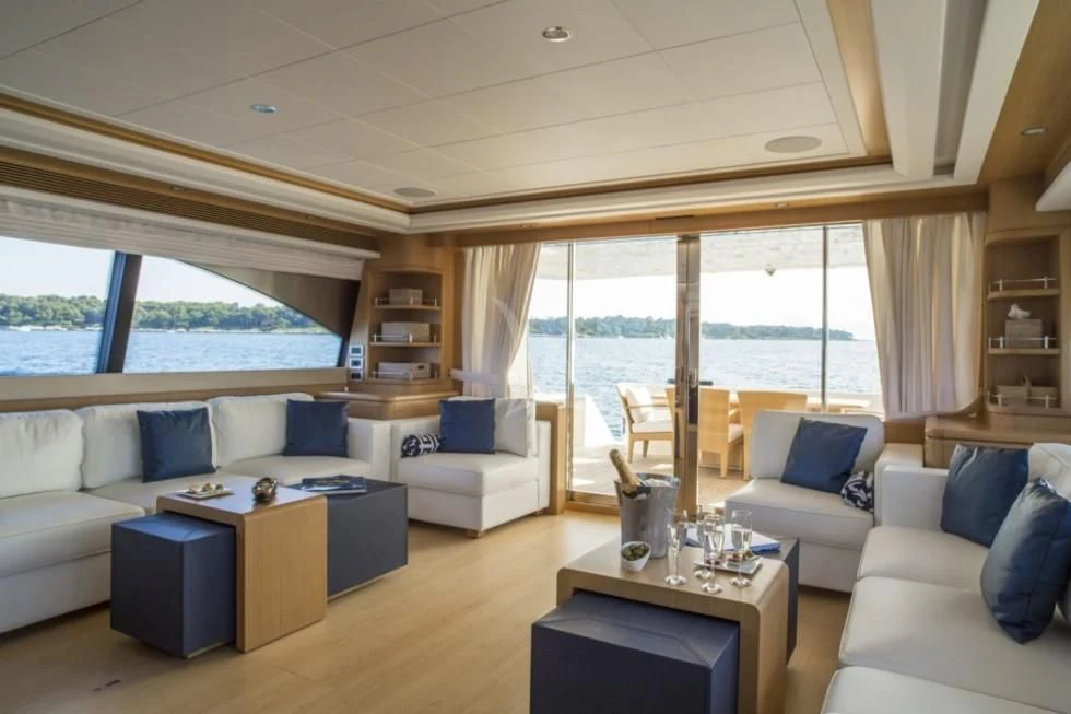a living room with a large window aboard PORTHOS SANS ABRI Yacht for Sale