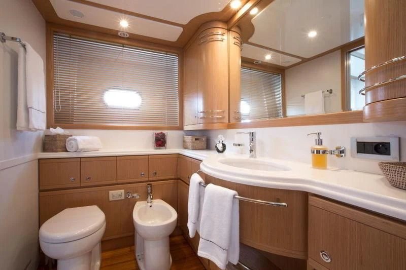 a bathroom with a toilet and a sink aboard PORTHOS SANS ABRI Yacht for Sale