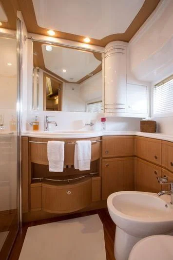 a bathroom with a toilet and a sink aboard PORTHOS SANS ABRI Yacht for Sale
