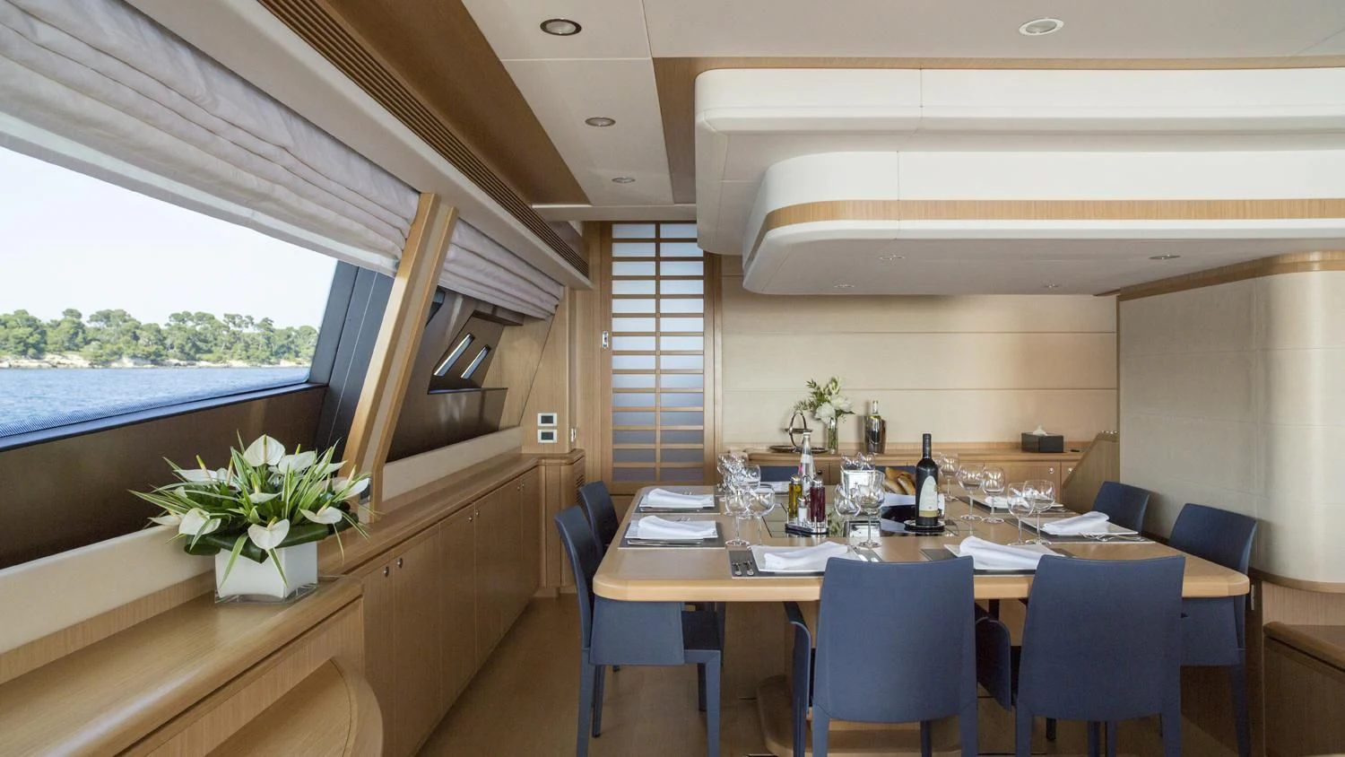 a dining room with a table and chairs aboard PORTHOS SANS ABRI Yacht for Sale