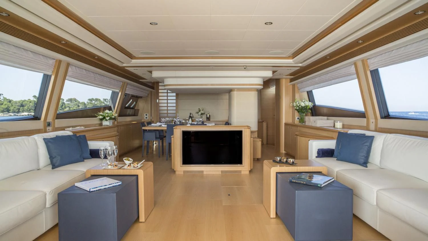 a living room with a fireplace aboard PORTHOS SANS ABRI Yacht for Sale