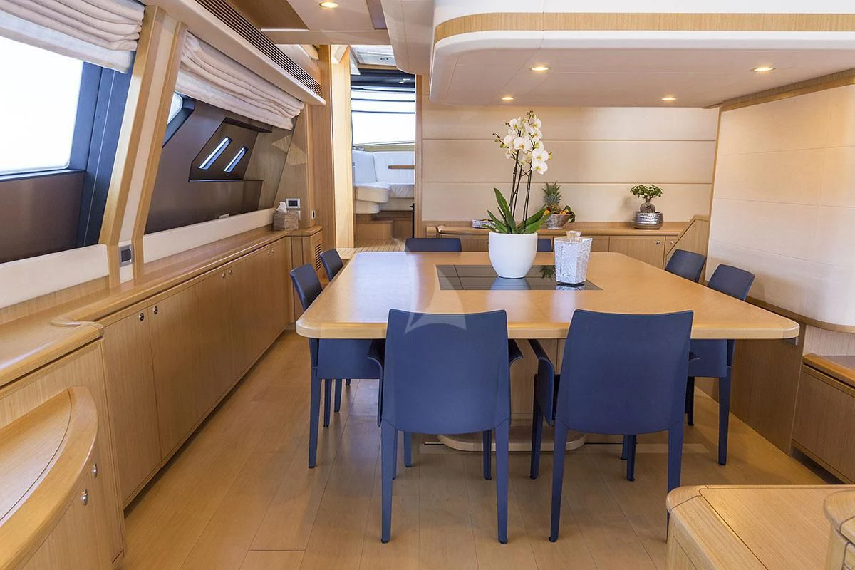 a large kitchen with a table and chairs aboard PORTHOS SANS ABRI Yacht for Sale