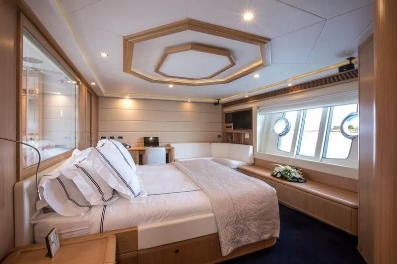 a room with a bed and a window aboard PORTHOS SANS ABRI Yacht for Sale