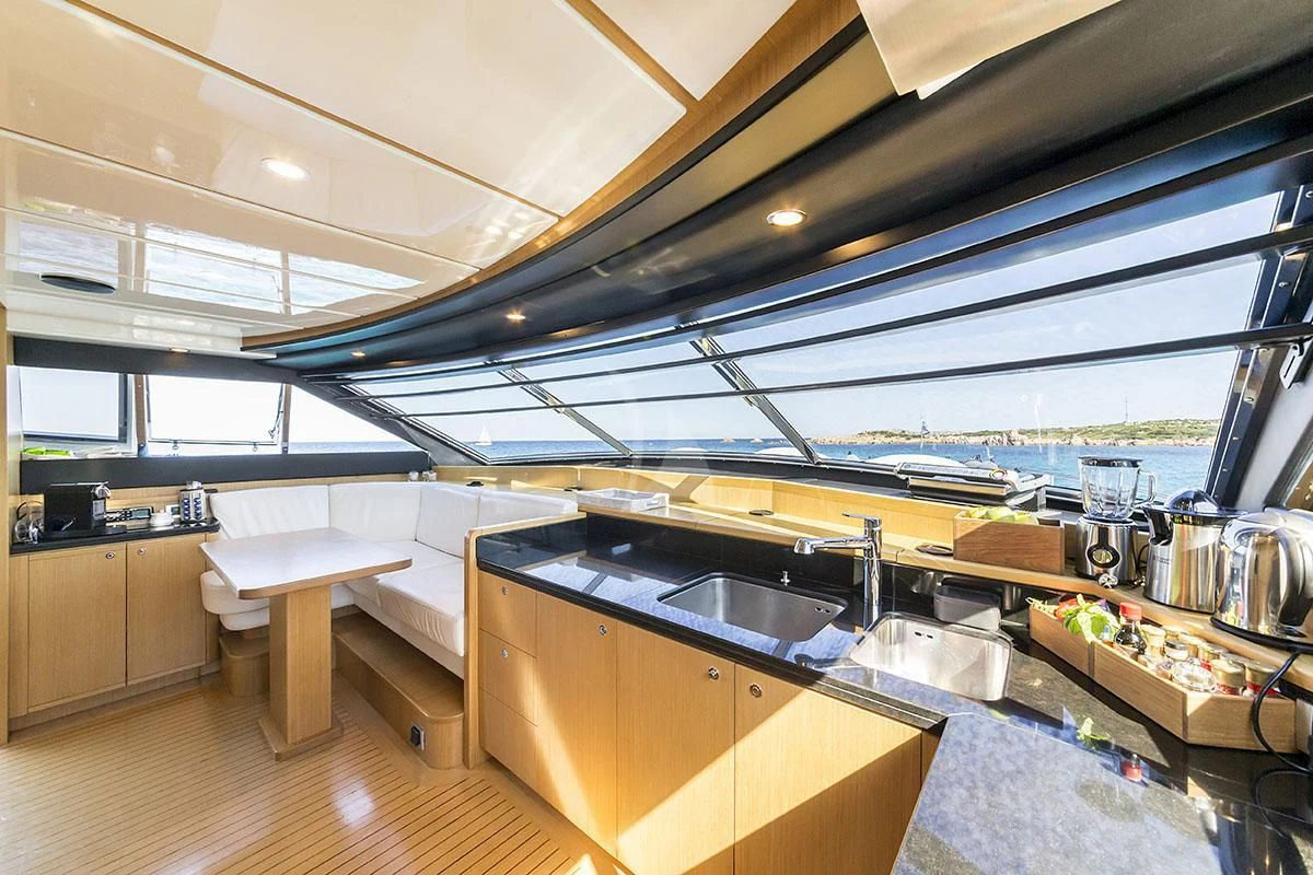 a kitchen with a large window aboard PORTHOS SANS ABRI Yacht for Sale
