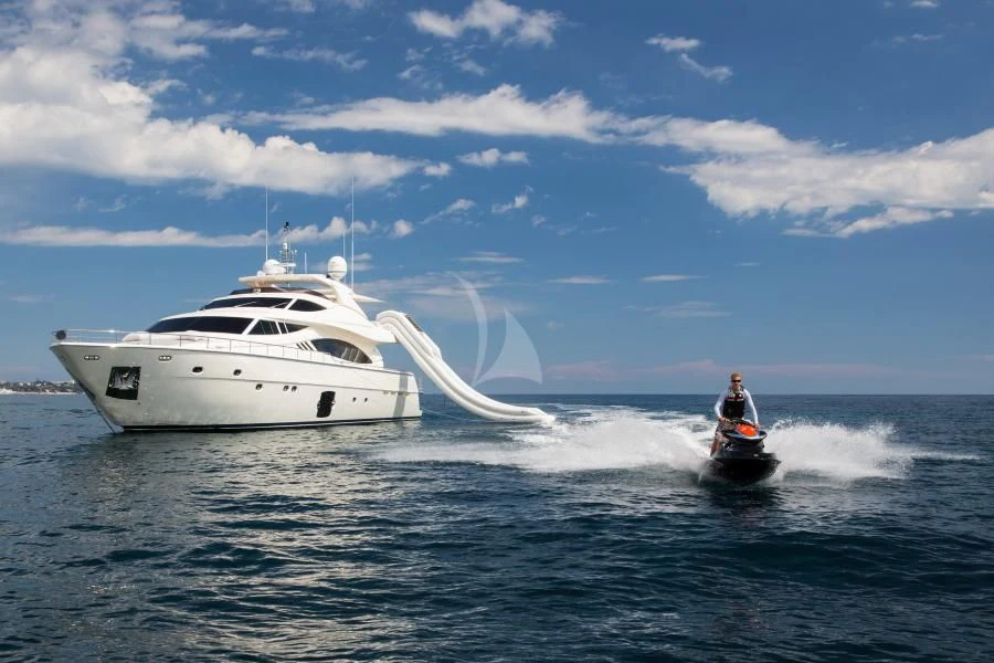 a person on a jet ski in the water next to a white boat aboard PORTHOS SANS ABRI Yacht for Sale