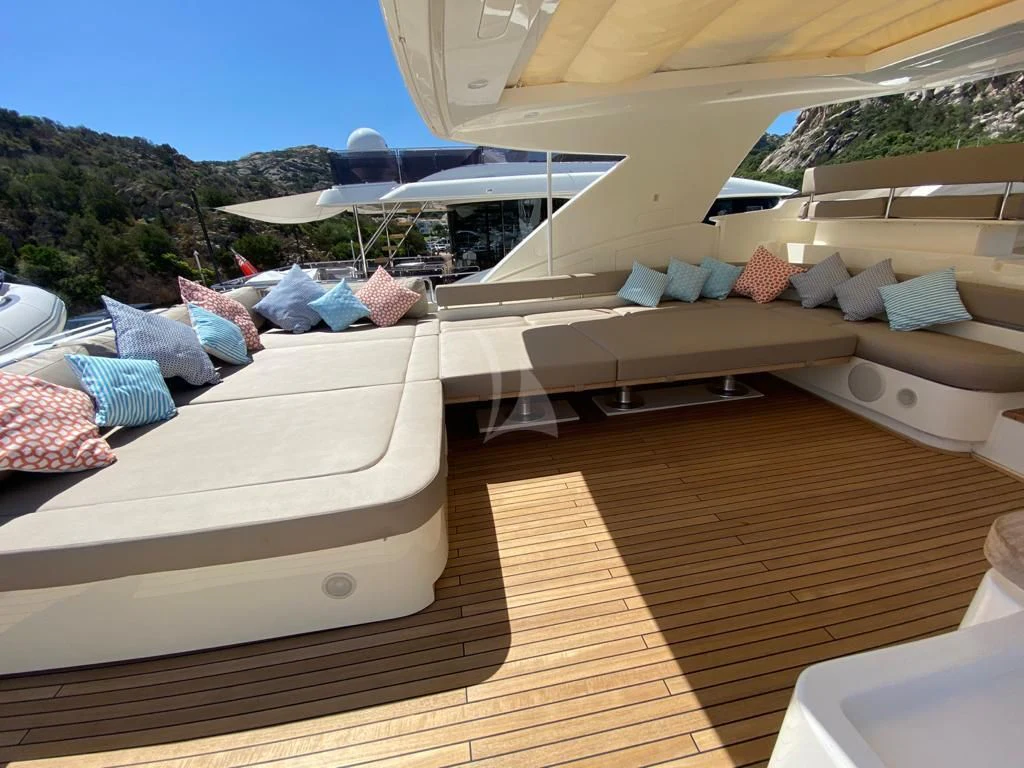 a deck with beds and a pool aboard PORTHOS SANS ABRI Yacht for Sale
