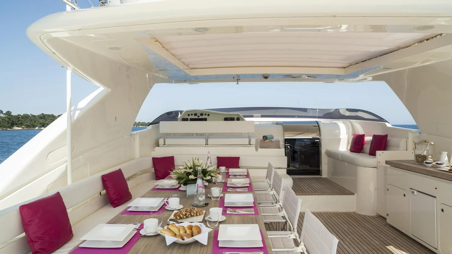 a large white boat with a table and chairs on a deck aboard PORTHOS SANS ABRI Yacht for Sale