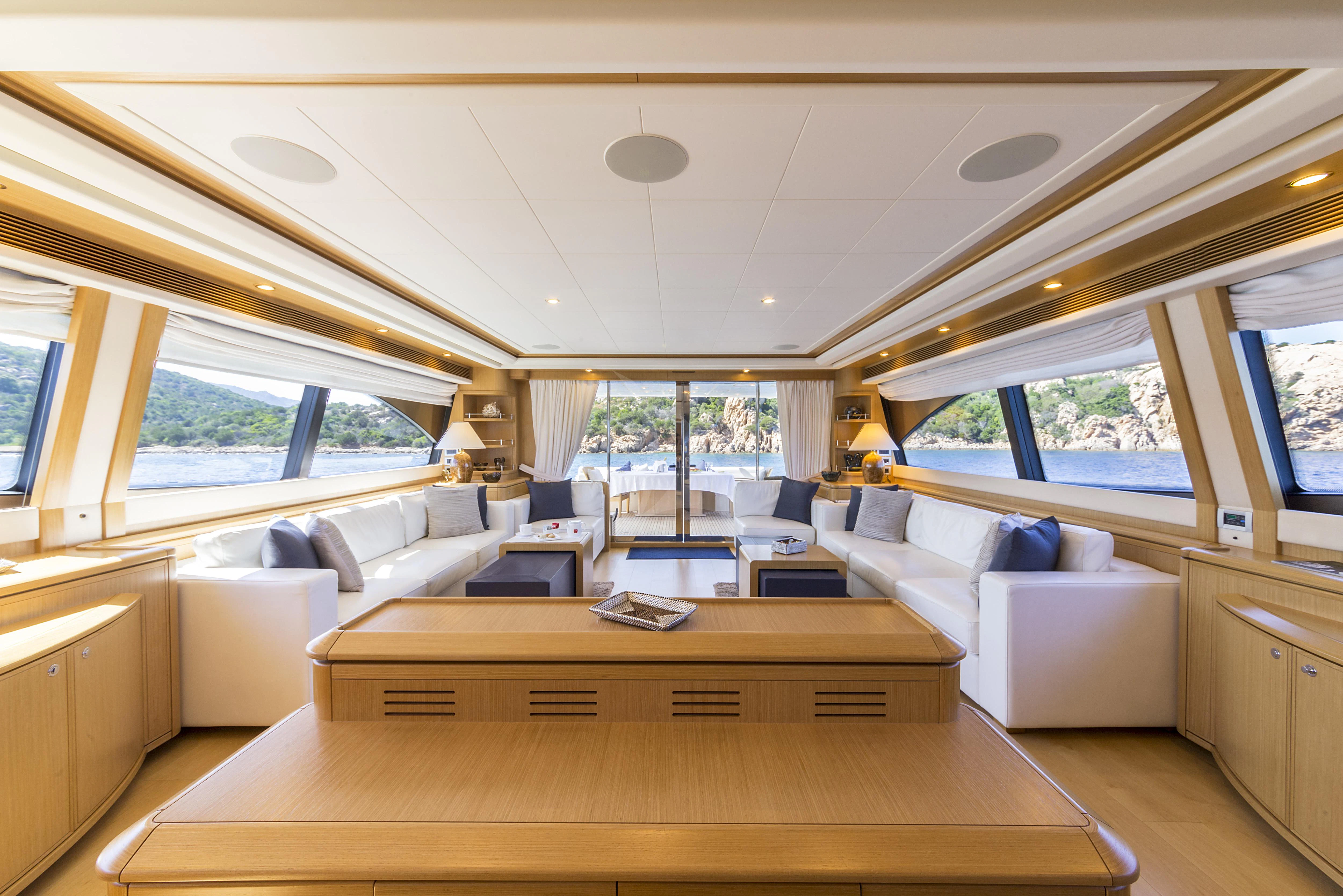 a living room with a large window aboard PORTHOS SANS ABRI Yacht for Sale