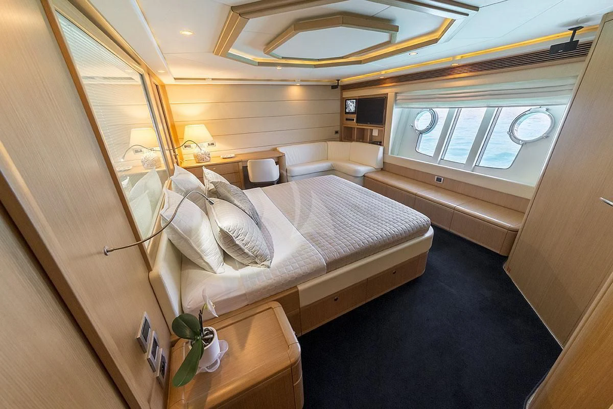 a room with a bed and a window aboard PORTHOS SANS ABRI Yacht for Sale