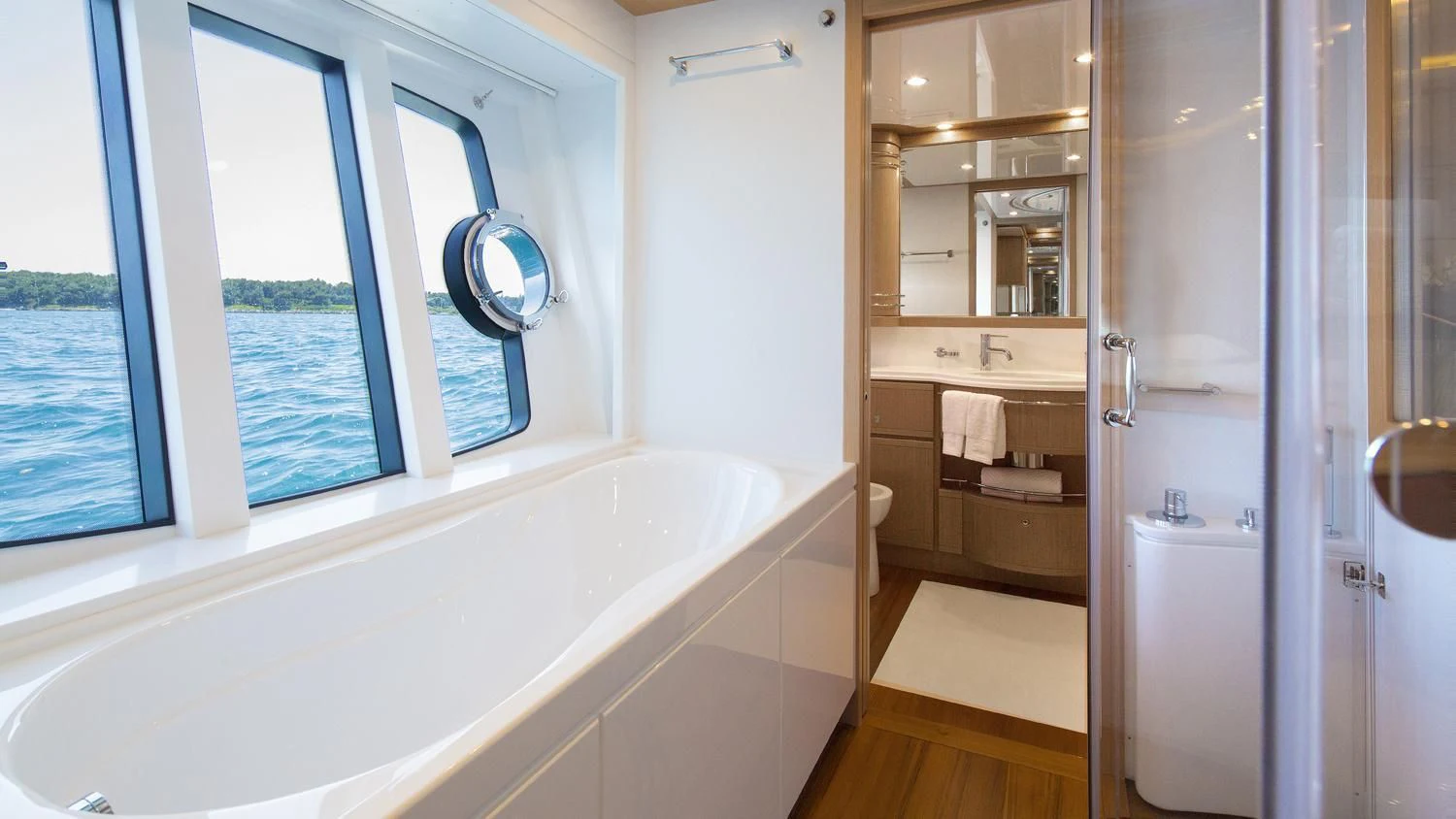 a bathroom with a bathtub and a shower aboard PORTHOS SANS ABRI Yacht for Sale