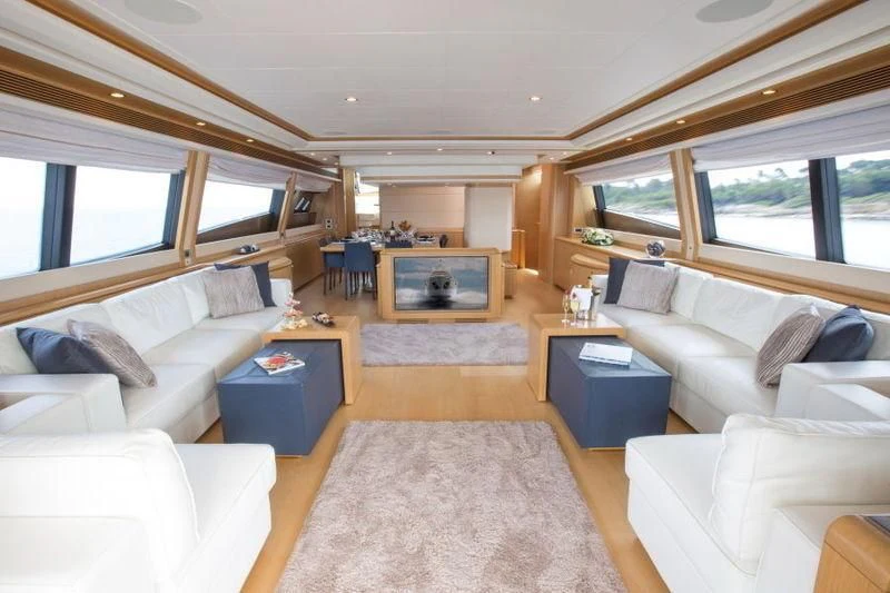 a living room with a large window aboard PORTHOS SANS ABRI Yacht for Sale