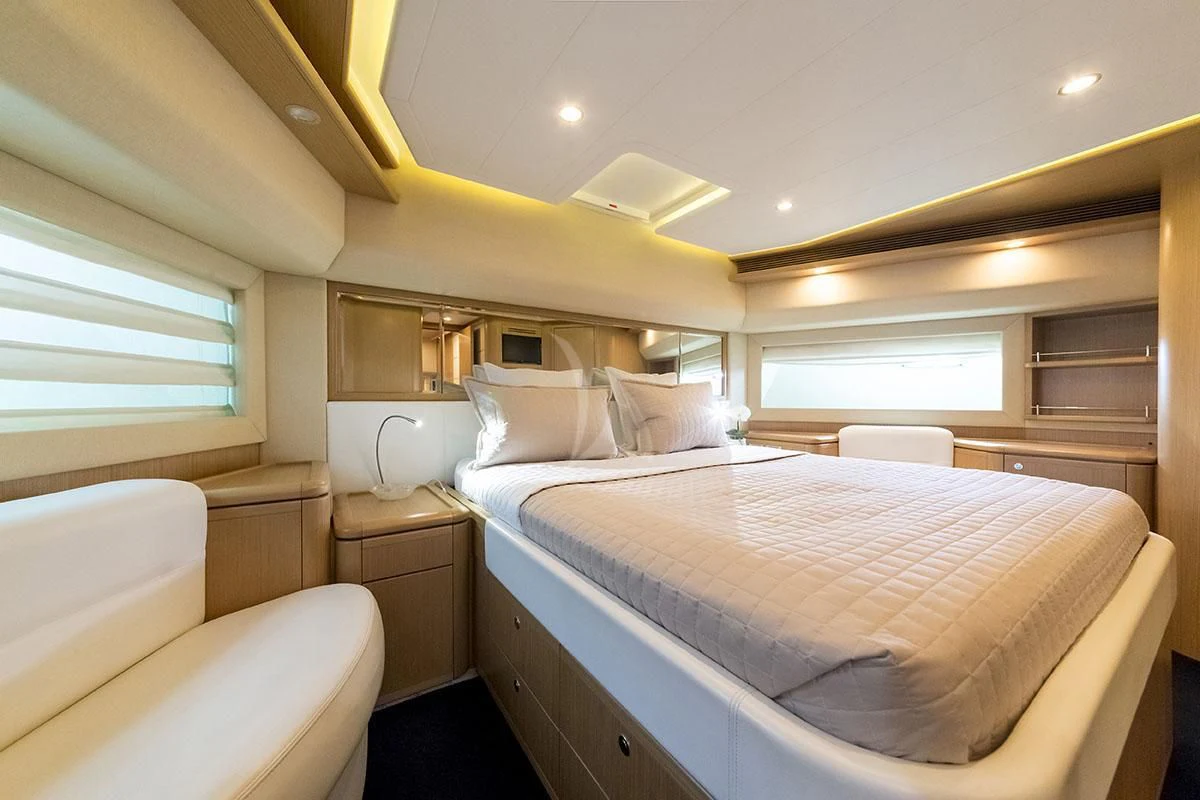 a room with a bed and a couch aboard PORTHOS SANS ABRI Yacht for Sale