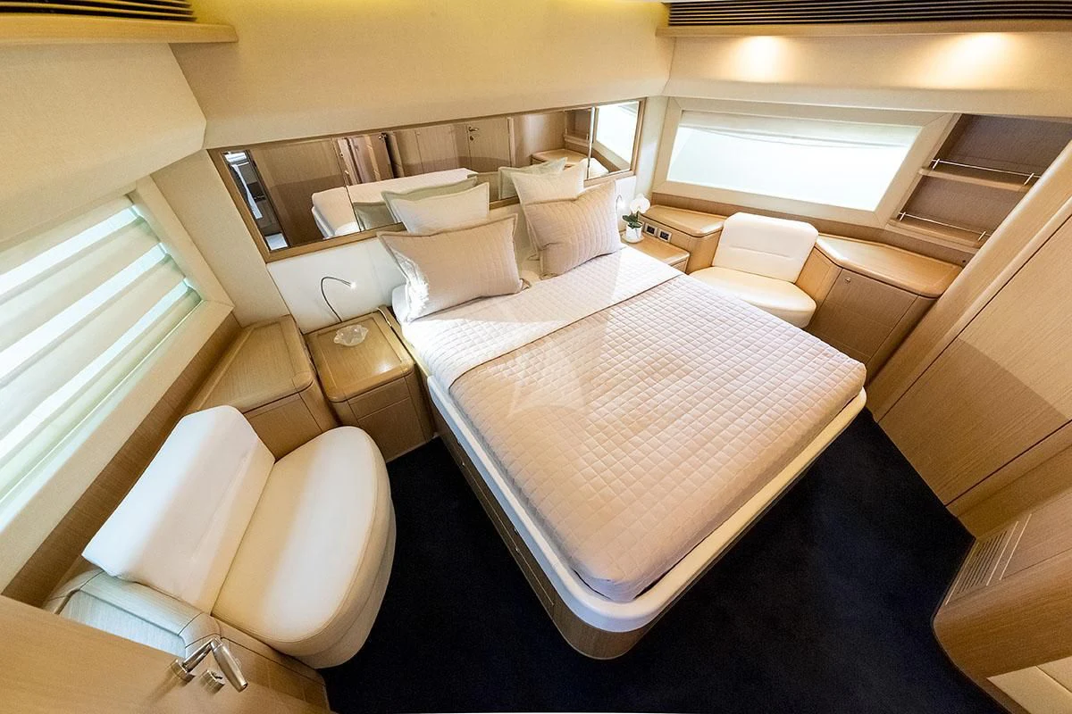 a room with a bed and a chair aboard PORTHOS SANS ABRI Yacht for Sale