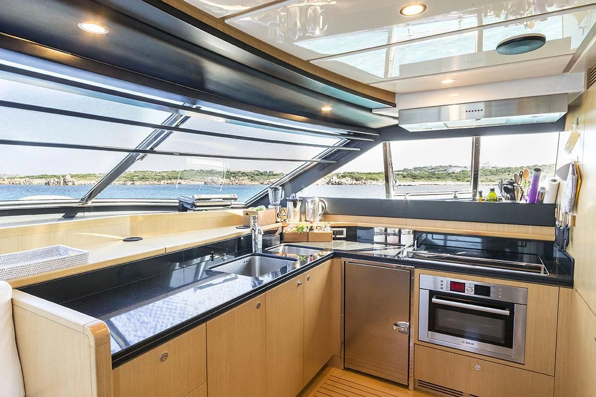 a kitchen with a large window aboard PORTHOS SANS ABRI Yacht for Sale