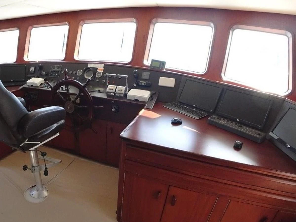 a desk with a computer and a chair aboard AGA 6 Yacht for Sale