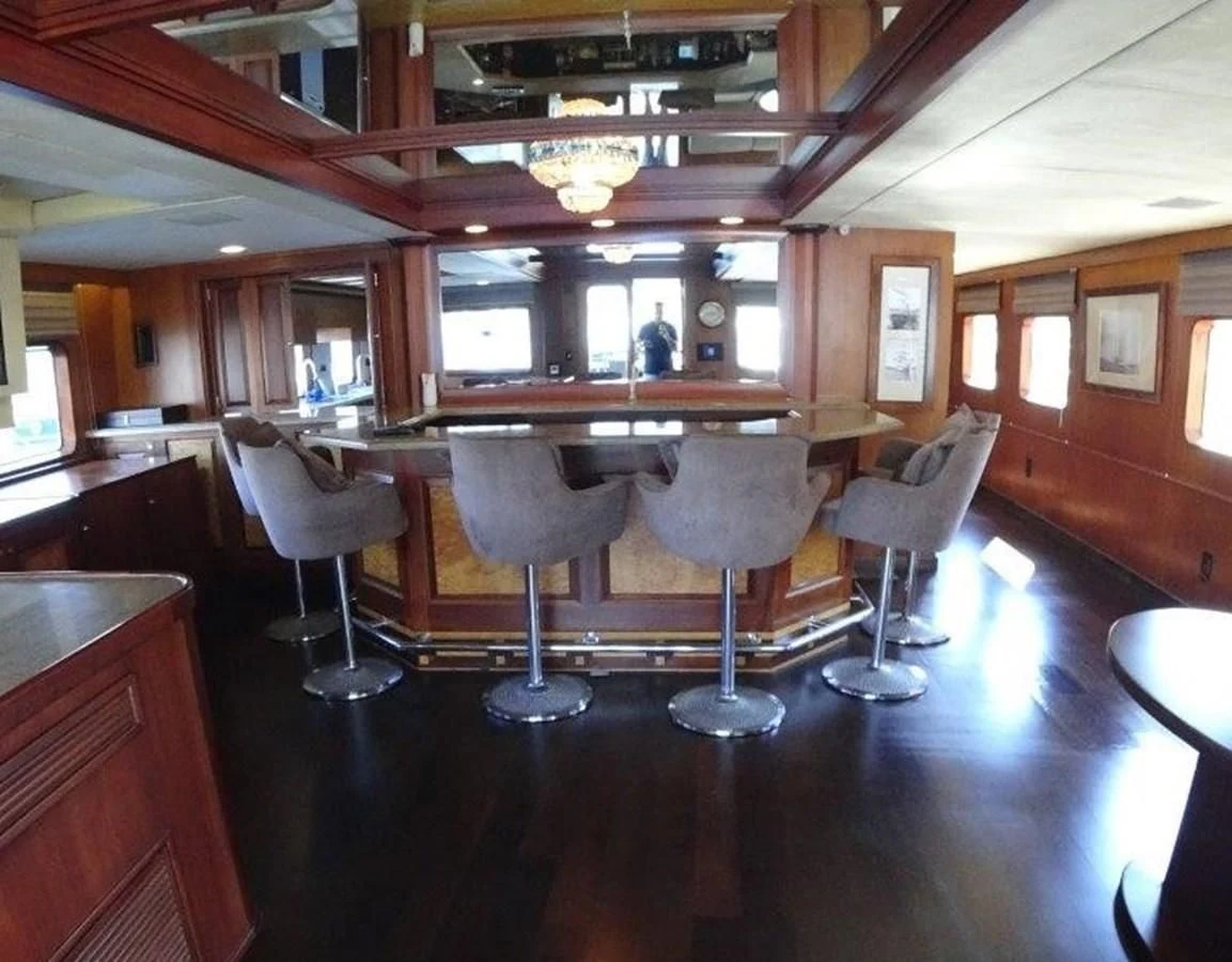 a bar with a bar and chairs aboard AGA 6 Yacht for Sale